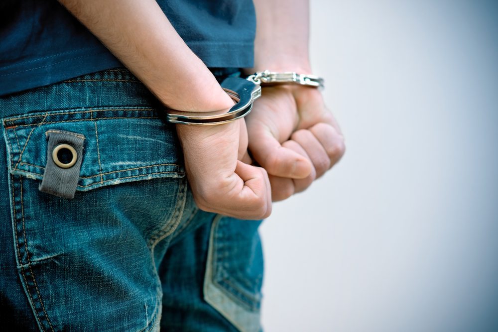 person in handcuffs